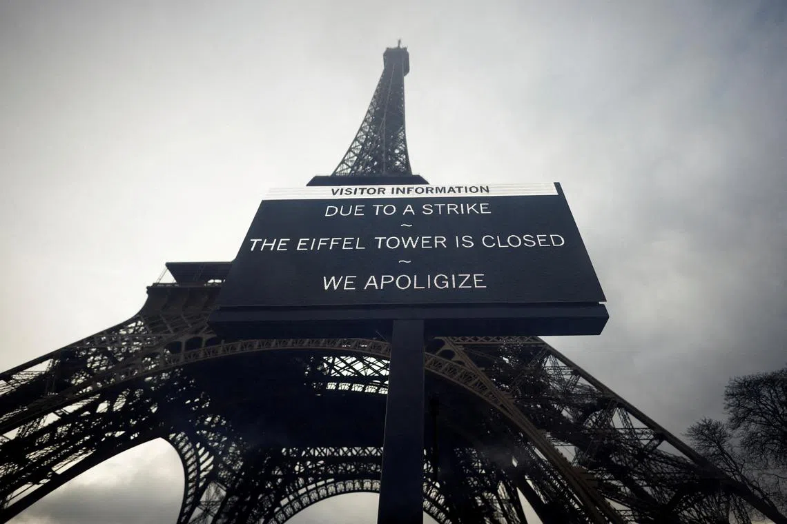 A sign reading "Due to a strike, the Eiffel Tower is closed. We apoligize" hangs in front of the Eiffel Tower in Paris, France, February 19, 2024. Picture taken through glass. REUTERS/Sarah Meyssonnier      TPX IMAGES OF THE DAY/File Photo