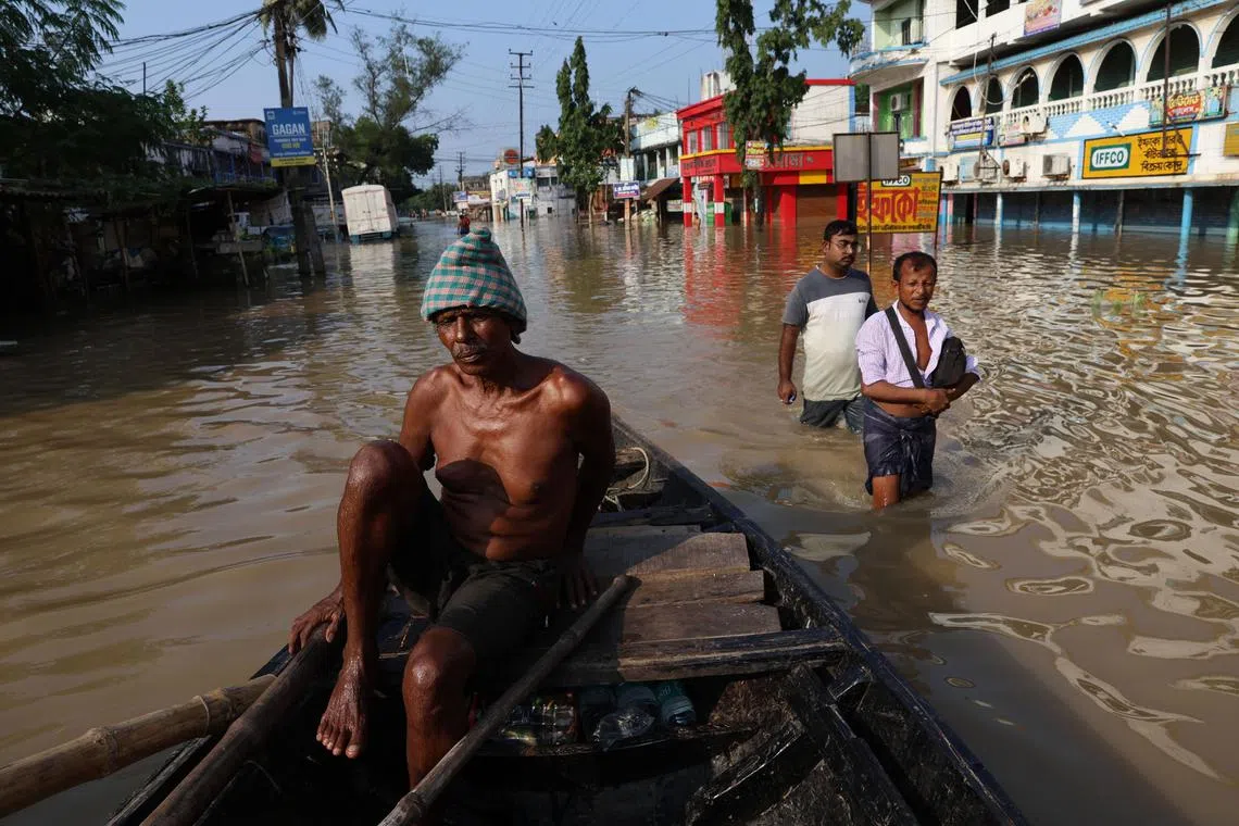 Television news images showed rescuers in boats ferrying people to safety in West Bengal state.