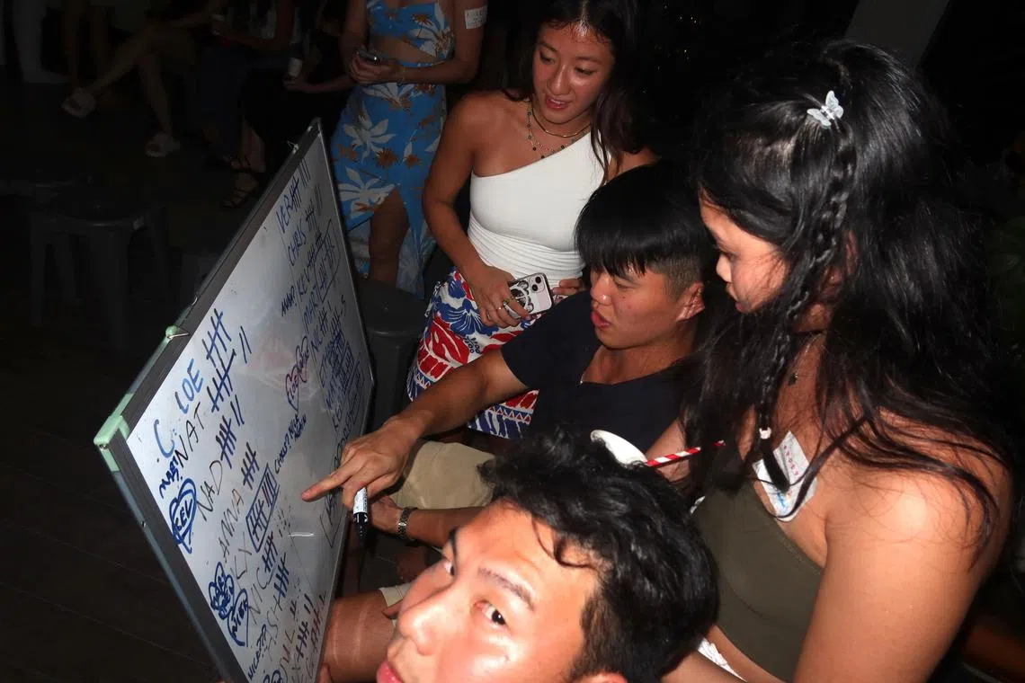 Participants playing a game at a singles' mixer organised by Tricia Pang and Ashley Yim.