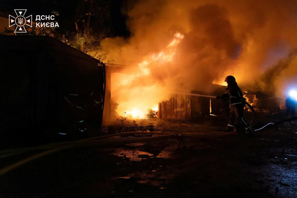 Firefighters work at a compound of car garages damaged during overnight Russian missile strikes, amid Russia's attack on Ukraine, in Kyiv, Ukraine August 8, 2026. Press service of the State Emergency Service of Ukraine/Handout via REUTERS