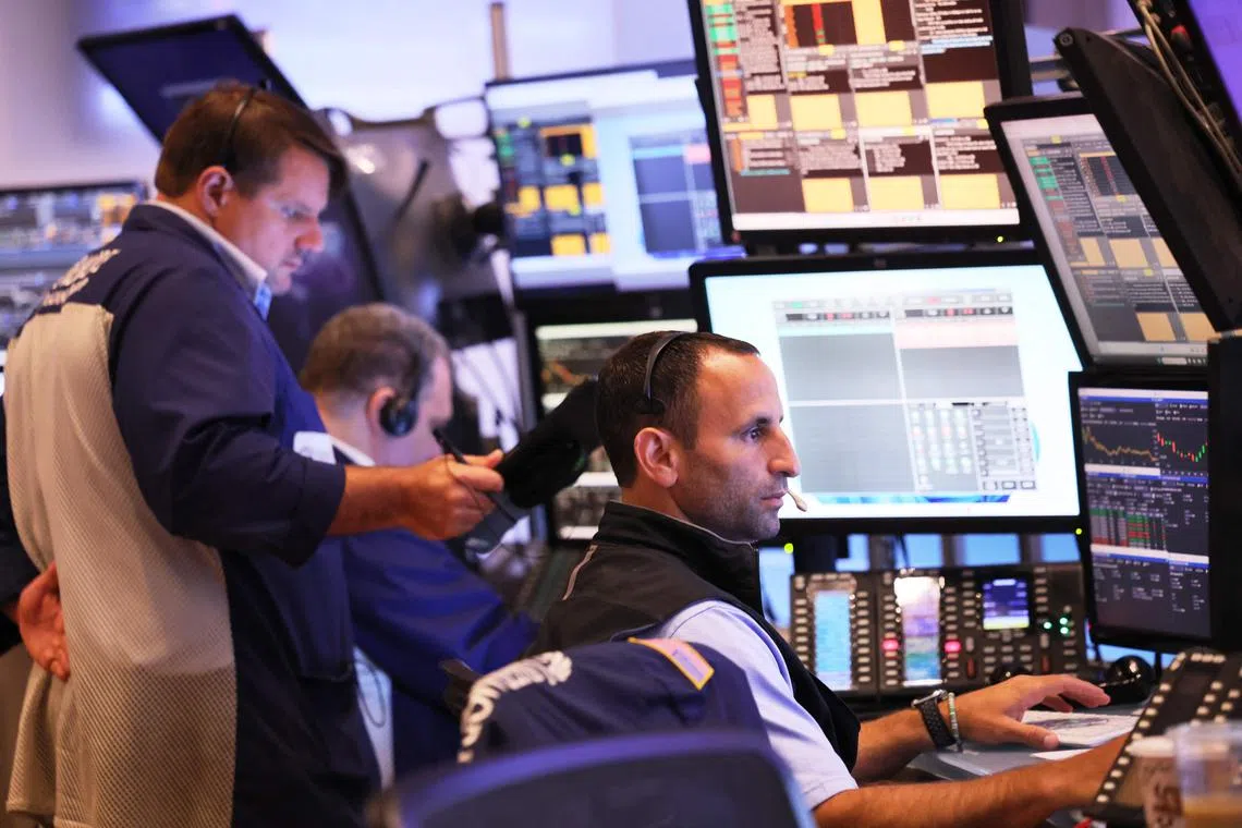 Traders work on the floor of the New York Stock Exchange, during morning trading, in New York City. 