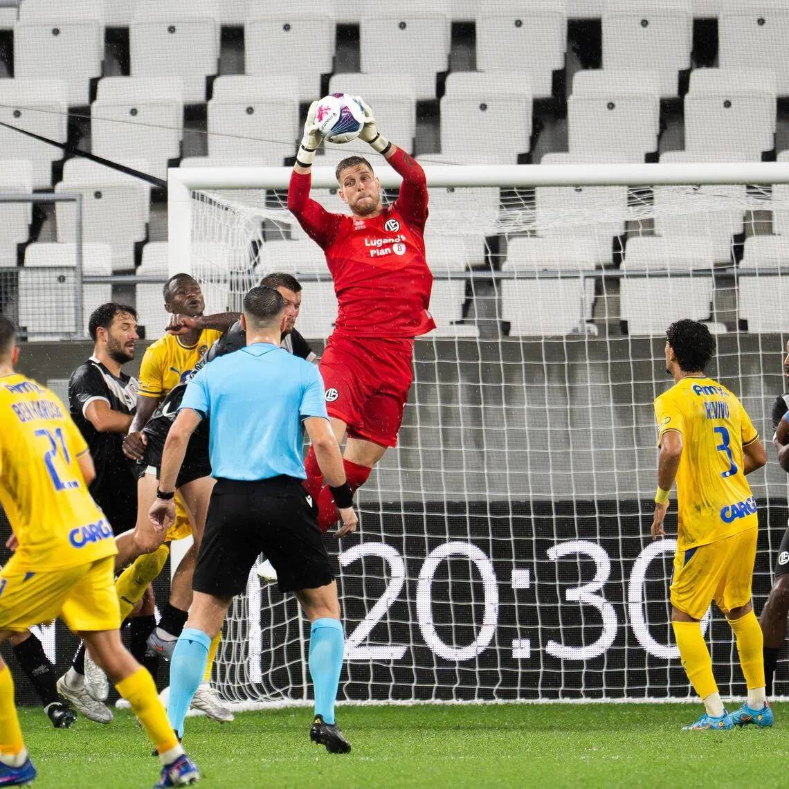 Goalkeeper David Von Ballmoos of Lugano in action during their 2-1 Conference League play-off, first-leg win over Maccabi Tel Aviv (in yellow) in Lugano, Switzerland, on Aug 20.