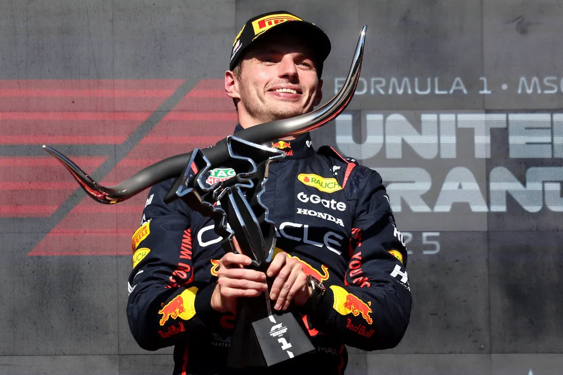 Formula One F1 - United States Grand Prix - Circuit of the Americas, Austin, Texas, U.S. - October 19, 2025 Red Bull's Max Verstappen celebrates with a trophy on the podium after winning the United States Grand Prix REUTERS/Jakub Porzycki