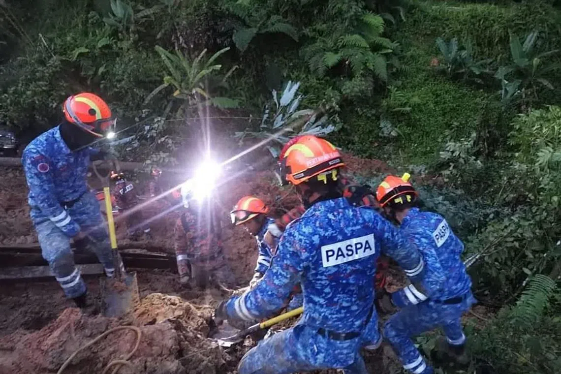 Rescuers at the site of the landslide in Batang Kali, Selangor state, Malaysia, Dec 16, 2022,