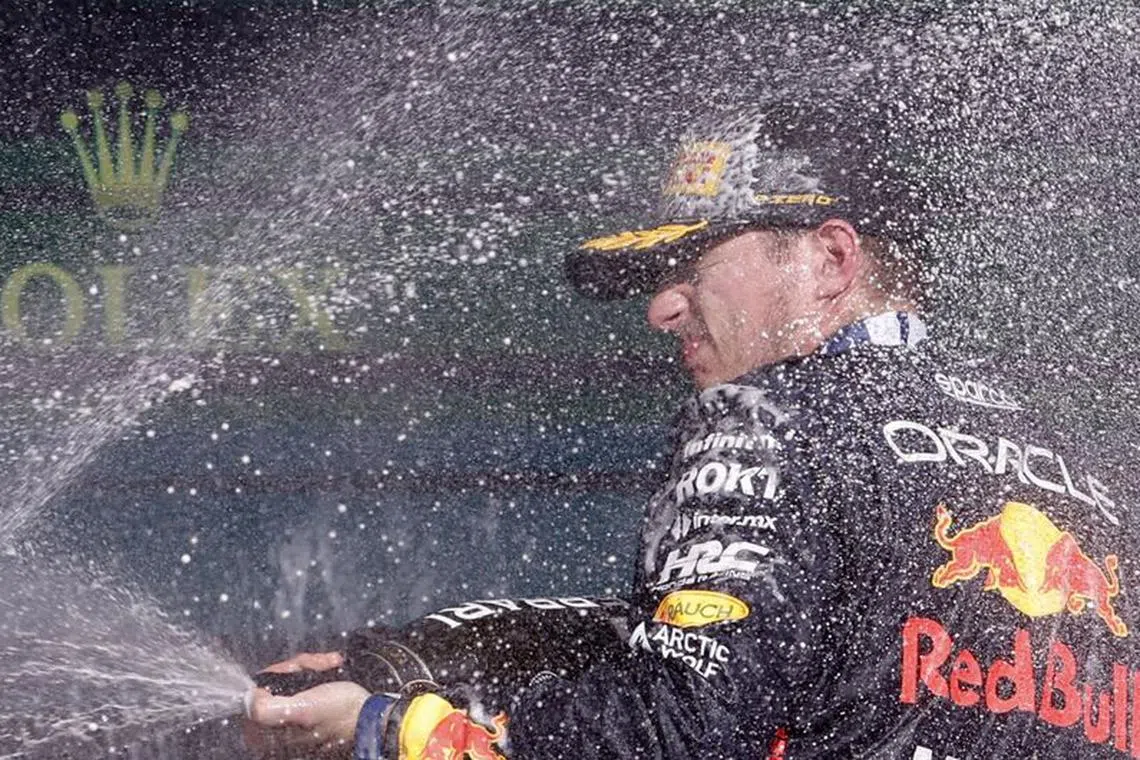 Formula One F1 - Brazilian Grand Prix - Jose Carlos Pace Circuit, Sao Paulo, Brazil - November 5, 2023 Red Bull's Max Verstappen celebrates with sparkling wine on the podium after winning the Brazilian Grand Prix REUTERS/Amanda Perobelli
