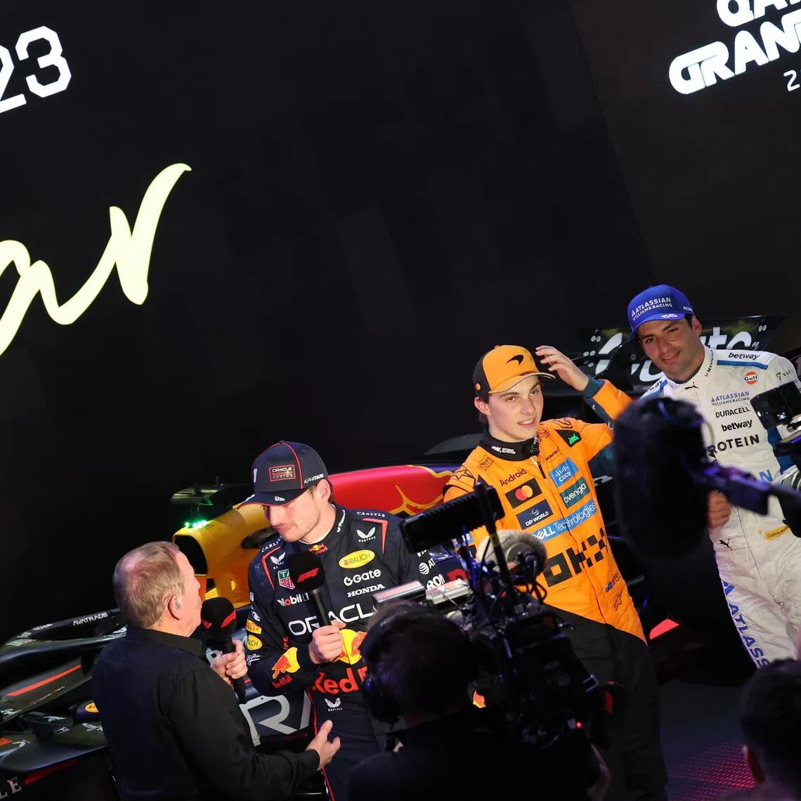 Race winner Max Verstappen (second from left), McLaren's Oscar Piastri and Williams' Carlos Sainz (far right) at post-race interviews after the Qatar Grand Prix.