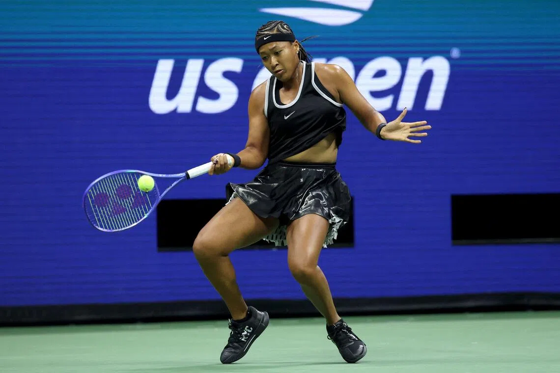 Naomi Osaka playing in an outfit inspired by retired NBA star Allen Iverson.