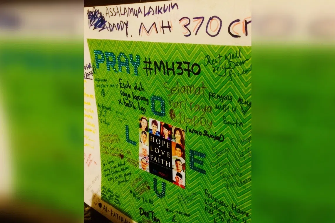 A card featuring pictures of the missing MH370 flight's cabin crew with wishes from their relatives, at a remembrance event just outside Kuala Lumpur in 2015.