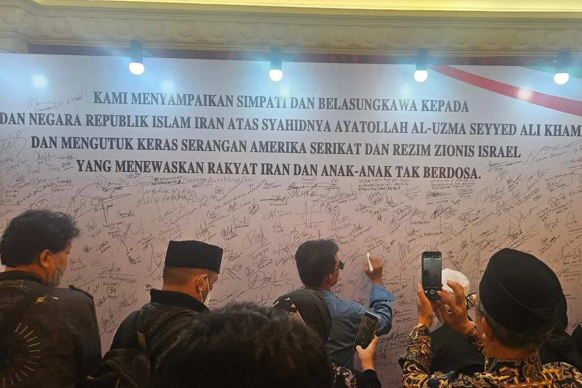 Visitors took turns to sign a condolence board at the official residence of Iranian Ambassador Mohammad Boroujerdi.