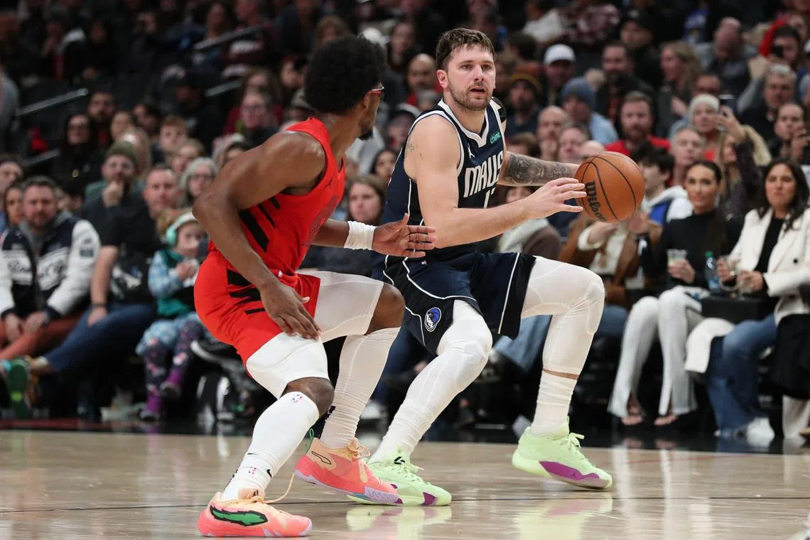 Scoot Henderson of the Portland Trail Blazers defends against Luka Doncic of the Dallas Mavericks during the fourth quarter at Moda Centre.