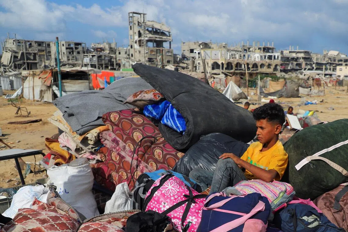 A boy sits on top of a pile of belongings, as displaced Palestinians get ready to flee, amid an Israeli military operation, after Israeli forces ordered residents of Gaza City to evacuate to the south, in Gaza City, September 19, 2025. REUTERS/Ebrahim Hajjaj     TPX IMAGES OF THE DAY     