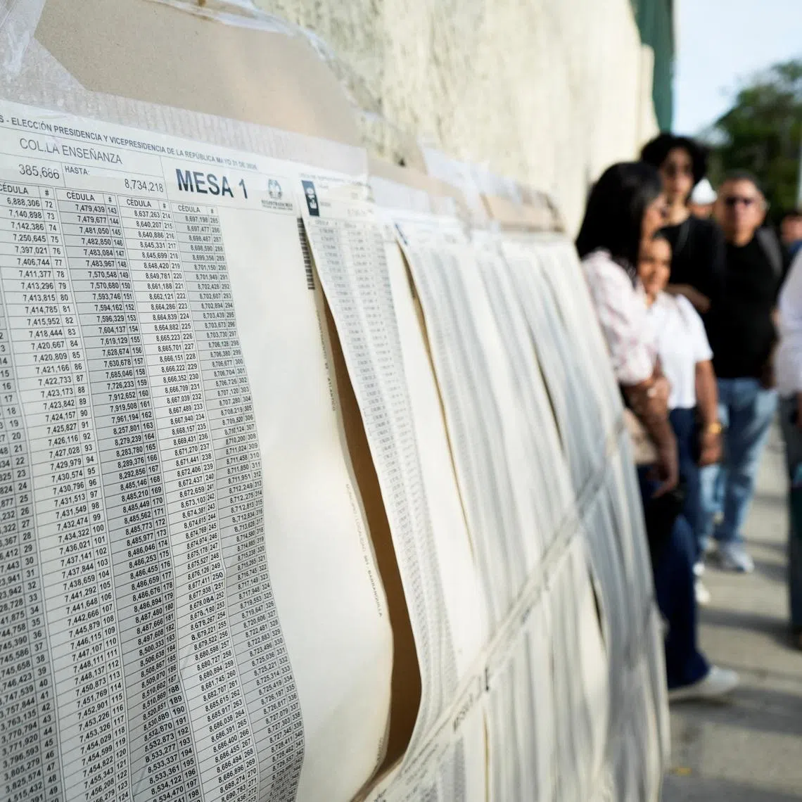 An election voter list posted outside a polling station as people wait to cast their votes during the first round of the presidential election in Colombia on May 31.
