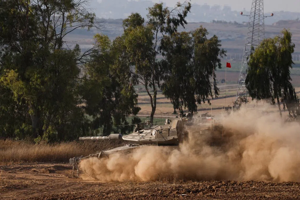 An Israeli tank manoeuvres near the Israel-Gaza border, amid the Israel-Hamas conflict, in Israel, June 27, 2024. REUTERS/Amir Cohen/File Photo