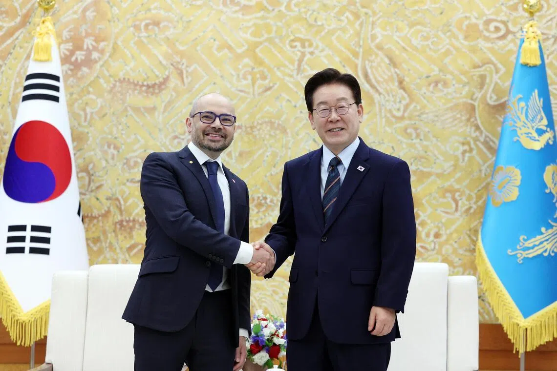 South Korean President Lee Jae Myung (R) shakes hands with Demis Hassabis (L), co-founder and CEO of Google DeepMind, during their meeting in Seoul, South Korea.