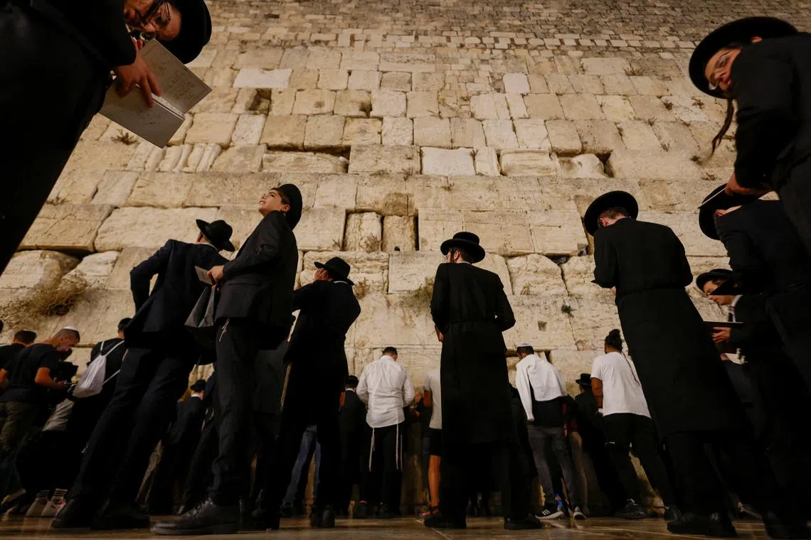 Jewish worshippers taking part in Slichot, a prayer in which Jews offer repentance and ask God to forgive their sins, ahead of Yom Kippur, the Jewish day of atonement at the Western Wall in Jerusalem's Old City, Sept 14.