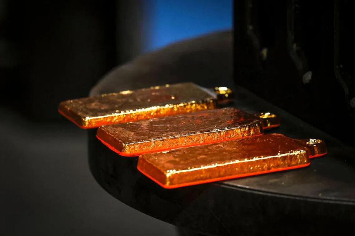 Gold bullion can be seen after being removed from casts at the ABC Refinery smelter in Sydney on April 29, 2025. 