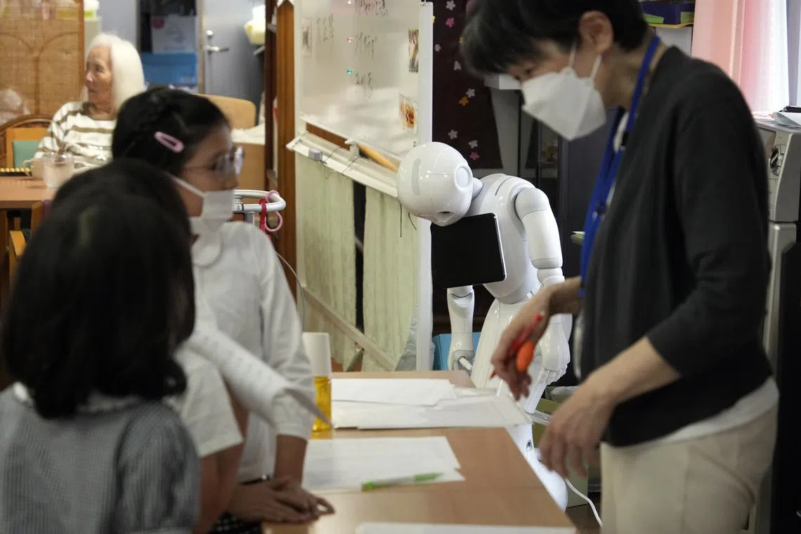 Pepper, a humanoid robot is seen switched off, as children attending an abacus class at the Shintomi nursing home in Tokyo, Japan on May 28, 2023.