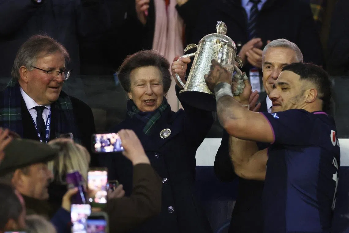Rugby Union - Six Nations Championship - Scotland v England - Murrayfield Stadium, Edinburgh, Scotland, Britain - February 14, 2026 Scotland's Sione Tuipulotu receives the Calcutta Cup trophy from Britain's Princess Anne as he celebrates with teammates after victory over England REUTERS/Russell Cheyne