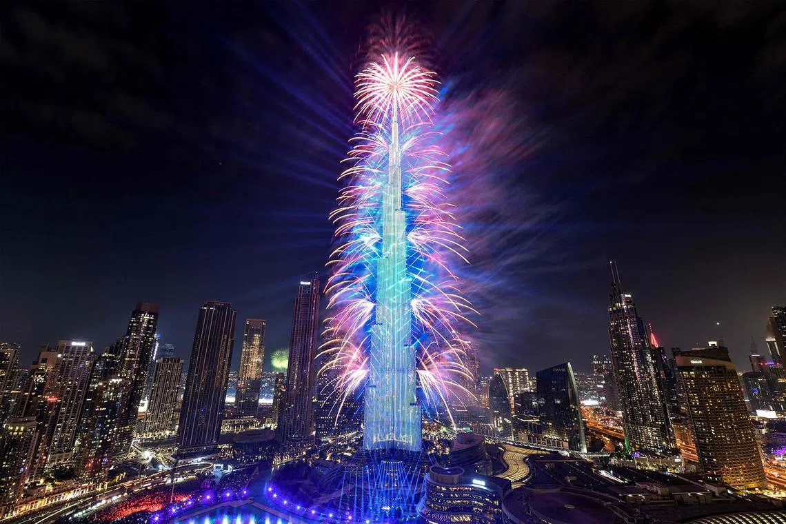 Fireworks lighting up the sky by the landmark Burj Khalifa skyscraper, the world’s tallest building, in Dubai on Jan 1, 2024. 