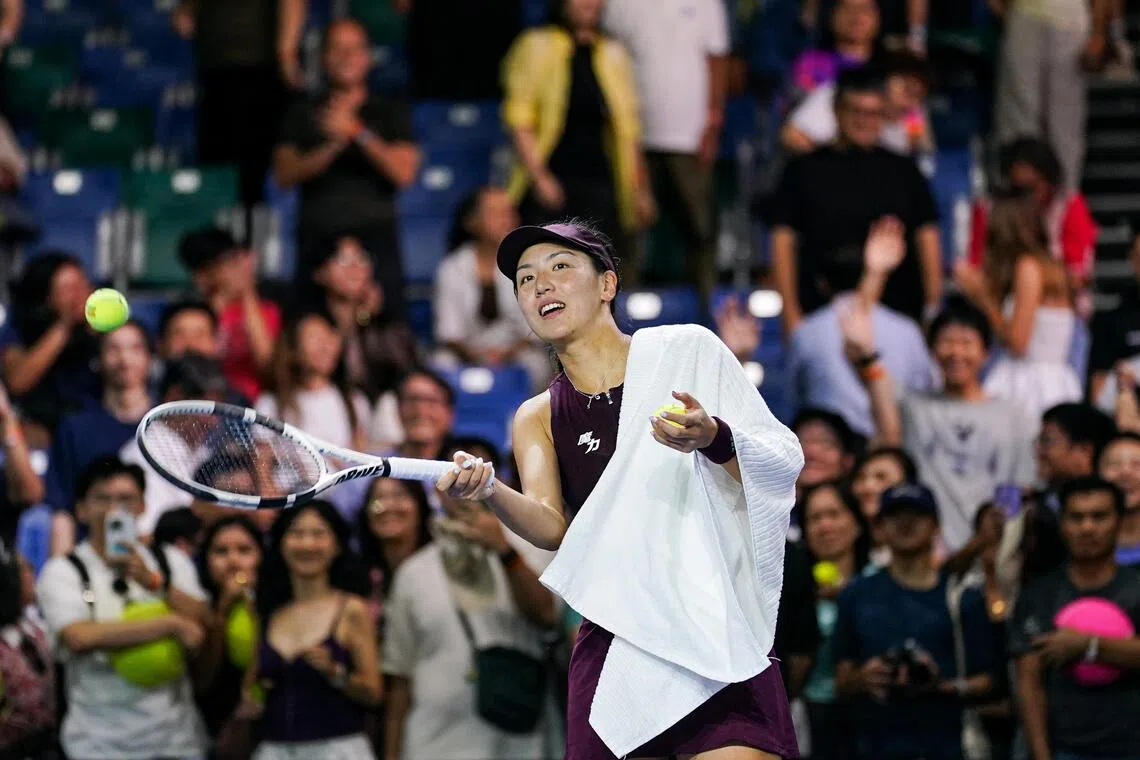 Wang Xinyu hitting tennis balls to fans after winning against Donna Vekic during their Singapore Tennis Open women’s singles Round of 32 match at OCBC Arena on Sept 22.