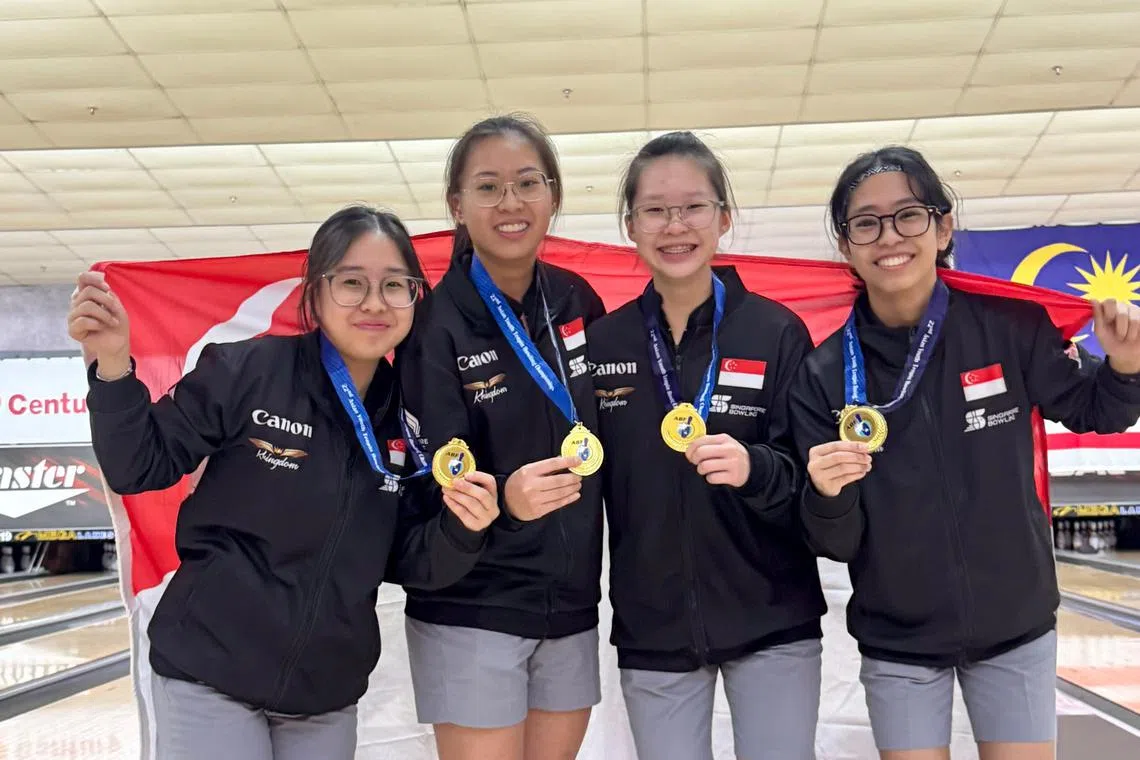 (From left) Singaporean bowlers Hazel Tan, Shirlene Wong, Lim Shi En and Nur Irdina Hazly with their gold medals after winning the girls' team event.
