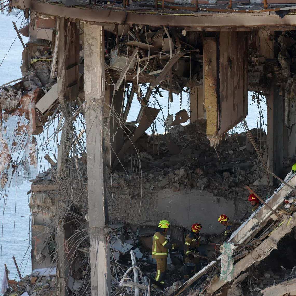 Ukrainian rescuers working at the site of a Russian air strike on a residential building in Odesa, southern Ukraine, on Sept 12.