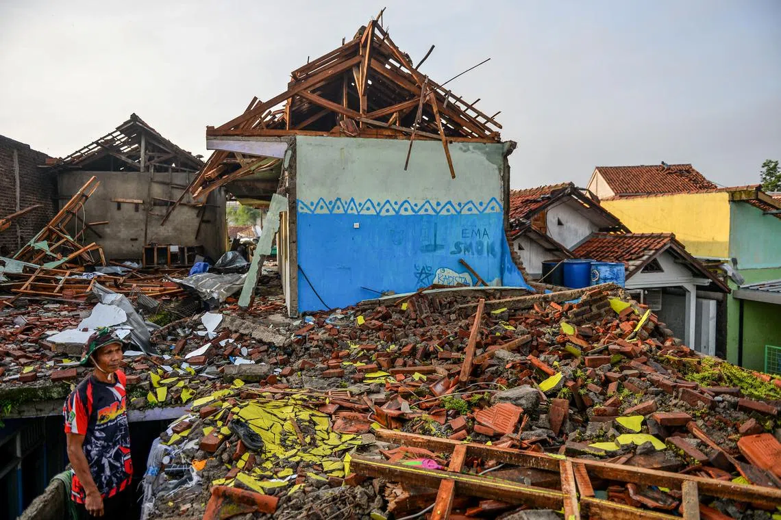 A man stands near damaged houses following a tornado at Sukadana village in Sumedang, West Java province, Indonesia, February 22, 2024, in this photo taken by Antara Foto. Antara Foto/Raisan Al Farisi/via REUTERS