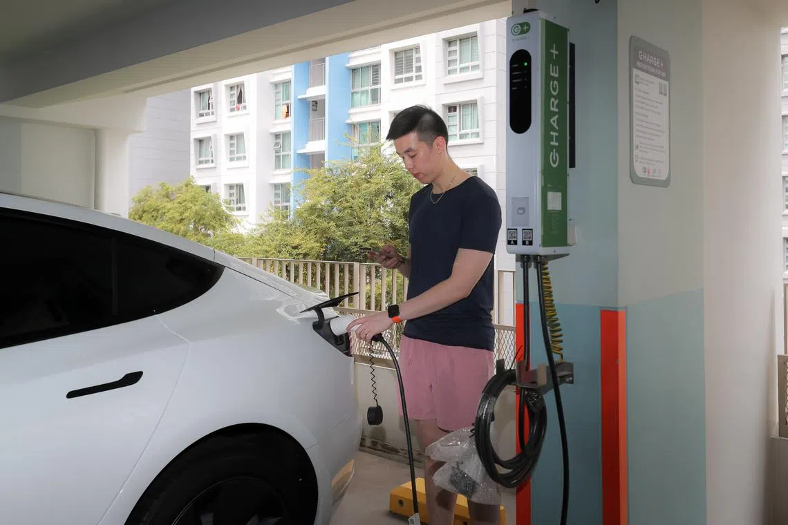 Punggol resident Alvin Tan, 27, using the new Charge  electric vehicle charger at block 603 multi-storey carpark on Punggol Road, 29 Oct 2022.