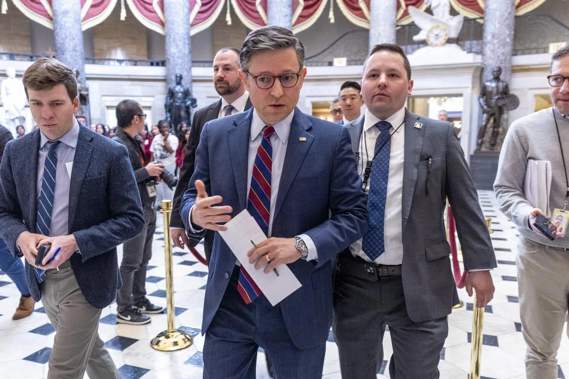 Speaker of the House Mike Johnson (centre) responding to a question from the media as he walks to the House chamber at the US Capitol in Washington, on March 6.
