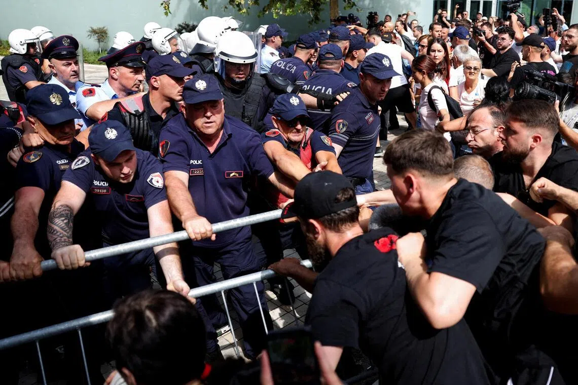 Police officers scuffle with protesters on July 2, during a demonstration against the government, following weeks of protests against the planned luxury resort.