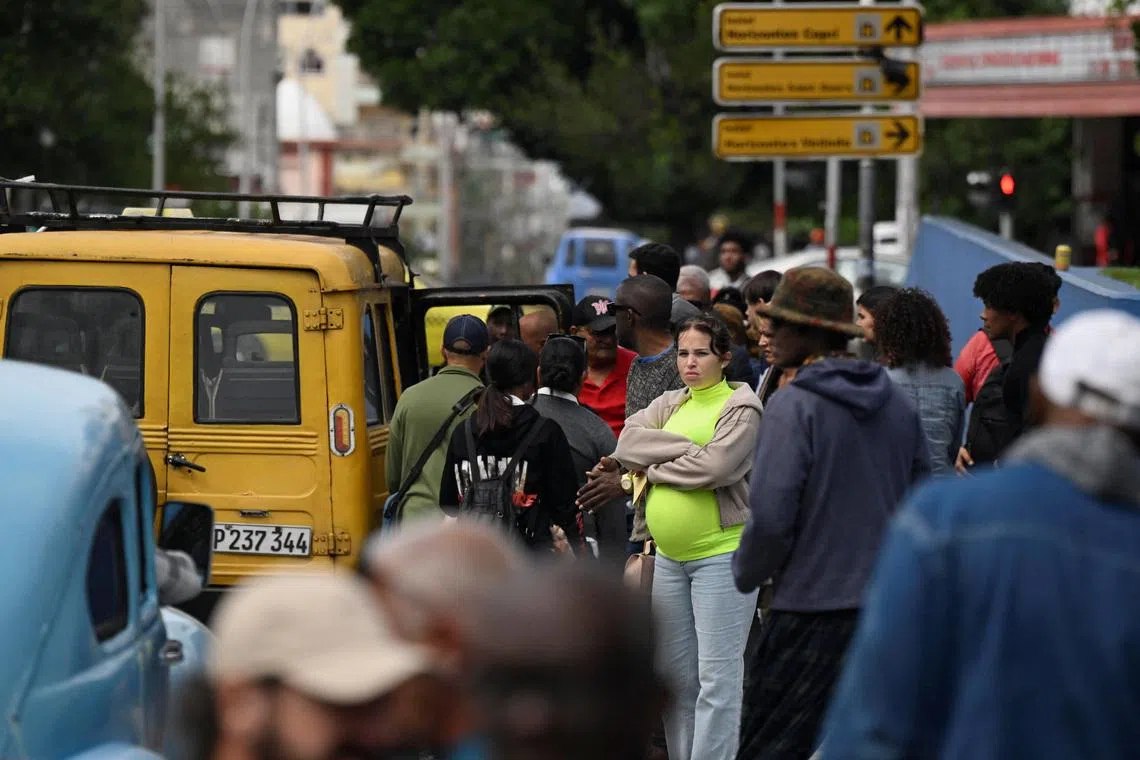 People wait for transportation as Cubans brace for fuel scarcity measures after U.S. tightened oil supply blockade, Havana, Cuba, February 6, 2026. REUTERS/Norlys Perez