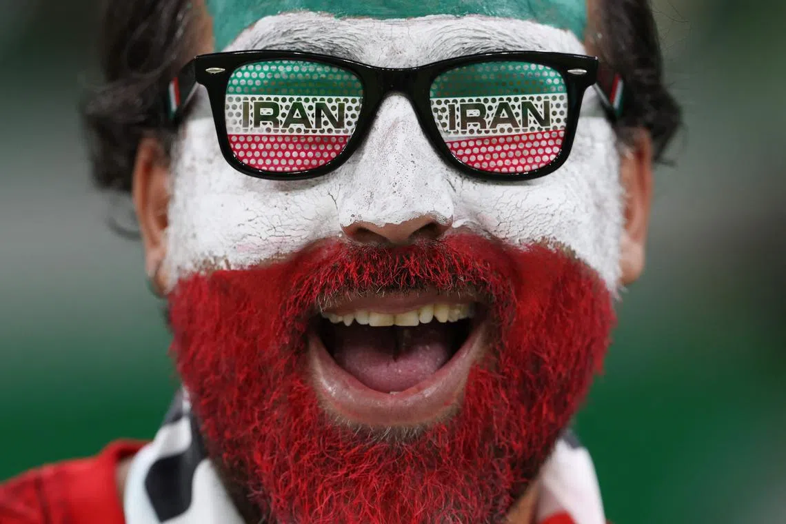 An Iran fan celebrates prior to the Qatar 2022 World Cup Group B football match between Iran and USA at the Al-Thumama Stadium in Doha on November 29, 2022.