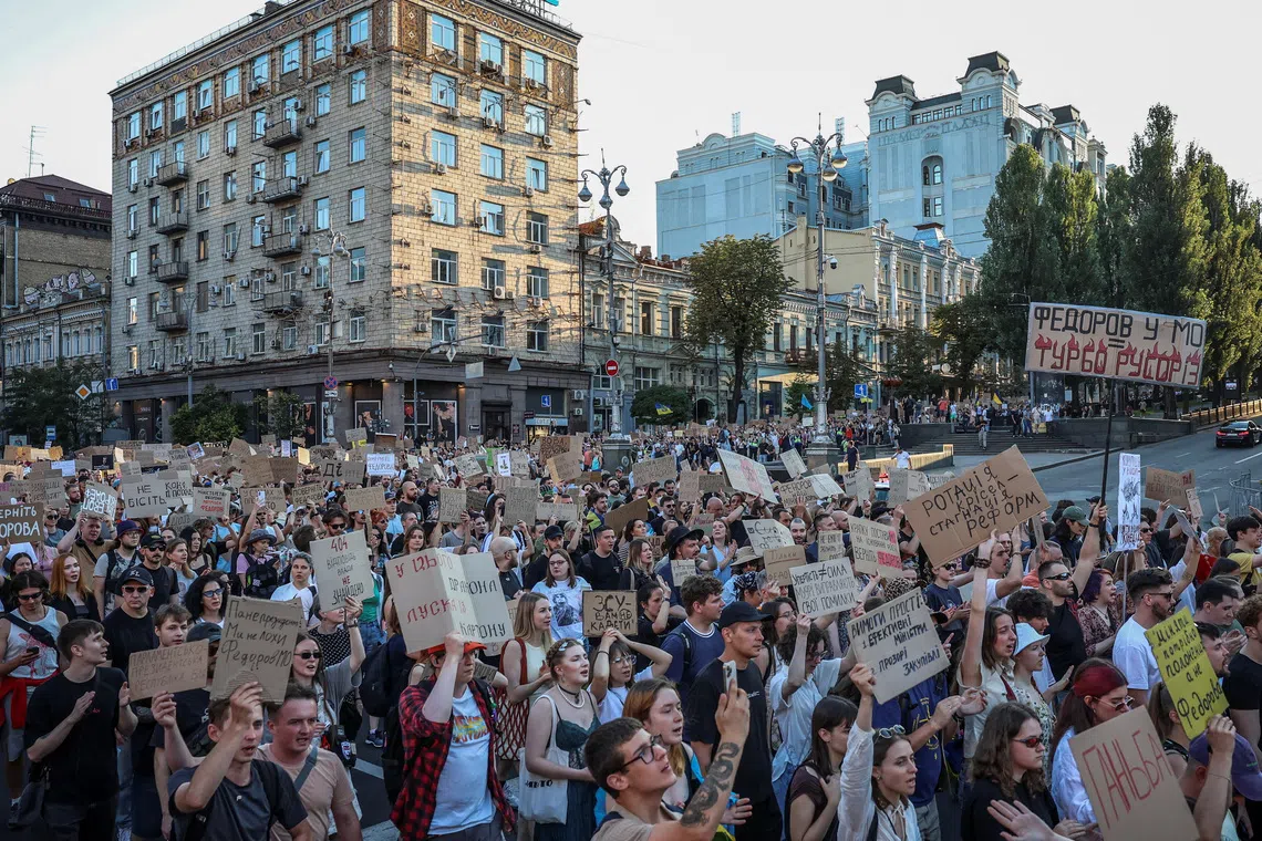 Participants hold posters and shout slogans during a rally to protest against Ukrainian President Volodymyr Zelenskiy's decision to replace Mykhailo Fedorov as Defence Minister, in Kyiv, Ukraine, on July 31, 2026.