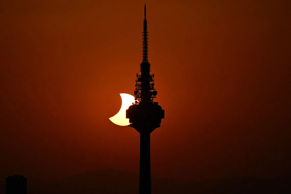 TOPSHOT - The Moon uncovers the Sun behind Torrespana TV tower, nicknamed "El Piruli" in the last moments of the solar eclipse as seen from the Cuna Verde viewpoint in Madrid, on August 12, 2026. Millions of Europeans contemplated the sky in awe today during a rare total solar eclipse that will plunge a swathe of Spain into an eerie daytime darkness. The shadow cast when the Moon covers the Sun began in Russia's remote Arctic north at around 1700 GMT and continued in an arc through Greenland and Iceland. Spain is where most people viewed the total eclipse, which crossed the country diagonally from the northern Atlantic coast to the Mediterranean Sea, where it vanished at around 1830 GMT. (Photo by JAVIER SORIANO / AFP)