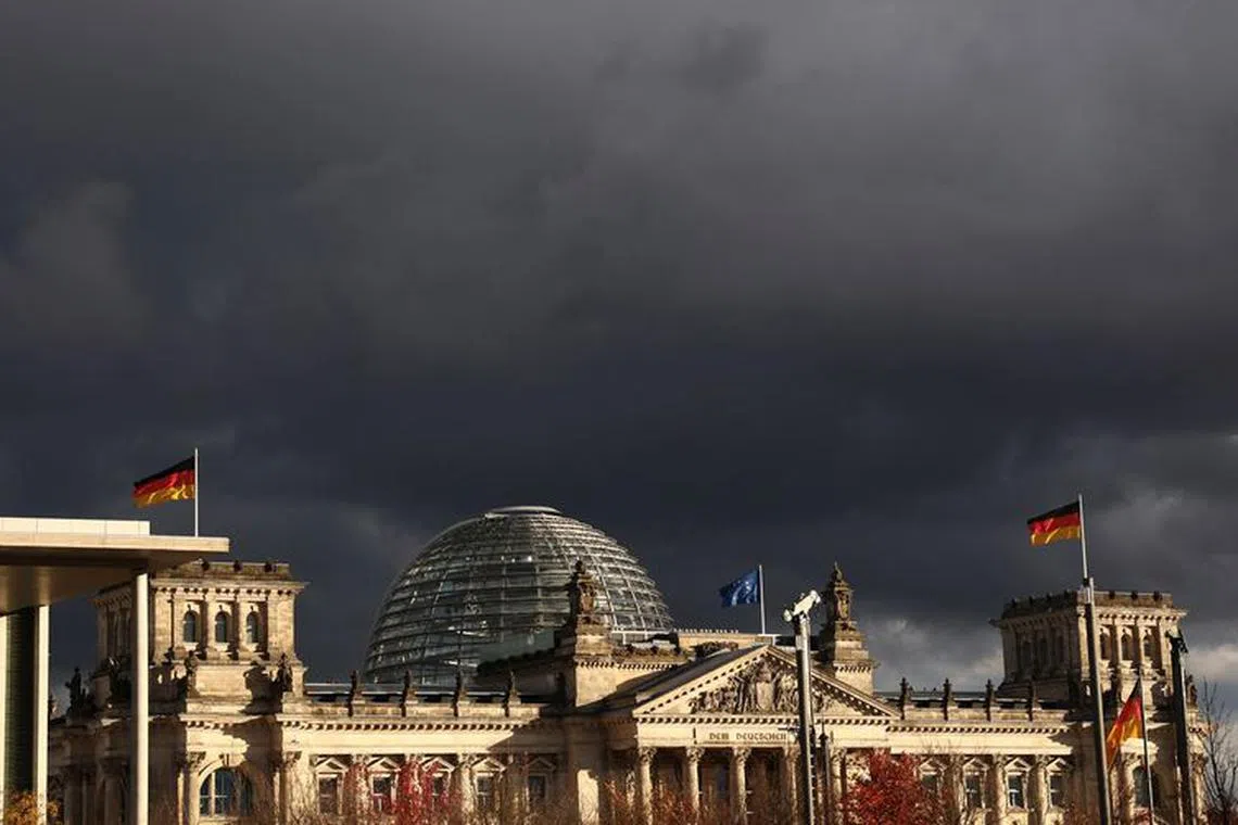 FILE PHOTO: Dark clouds are seen over the Reichstag building, Germany’s seat of the lower house of parliament Bundestag in Berlin, Germany, November 10, 2023. REUTERS/Liesa Johannssen/File Photo