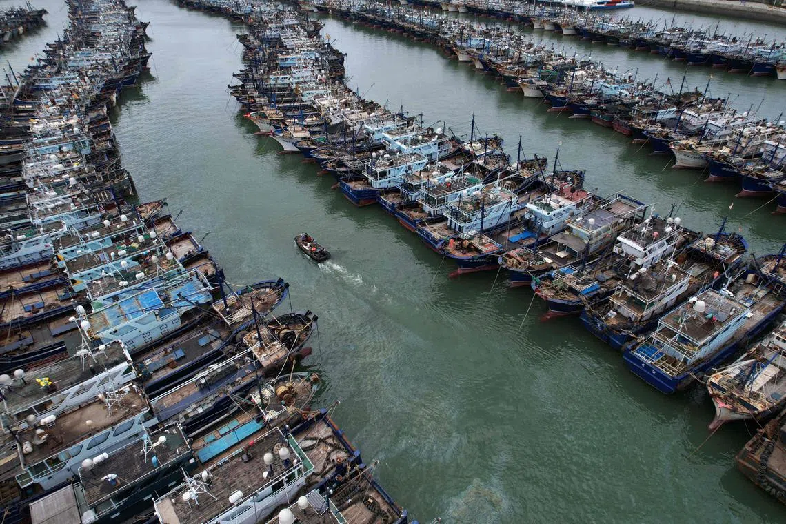 Fishing boats are moored at a port at Fujian province in preparation for the approaching Typhoon Doksuri on July 26, 2023. 