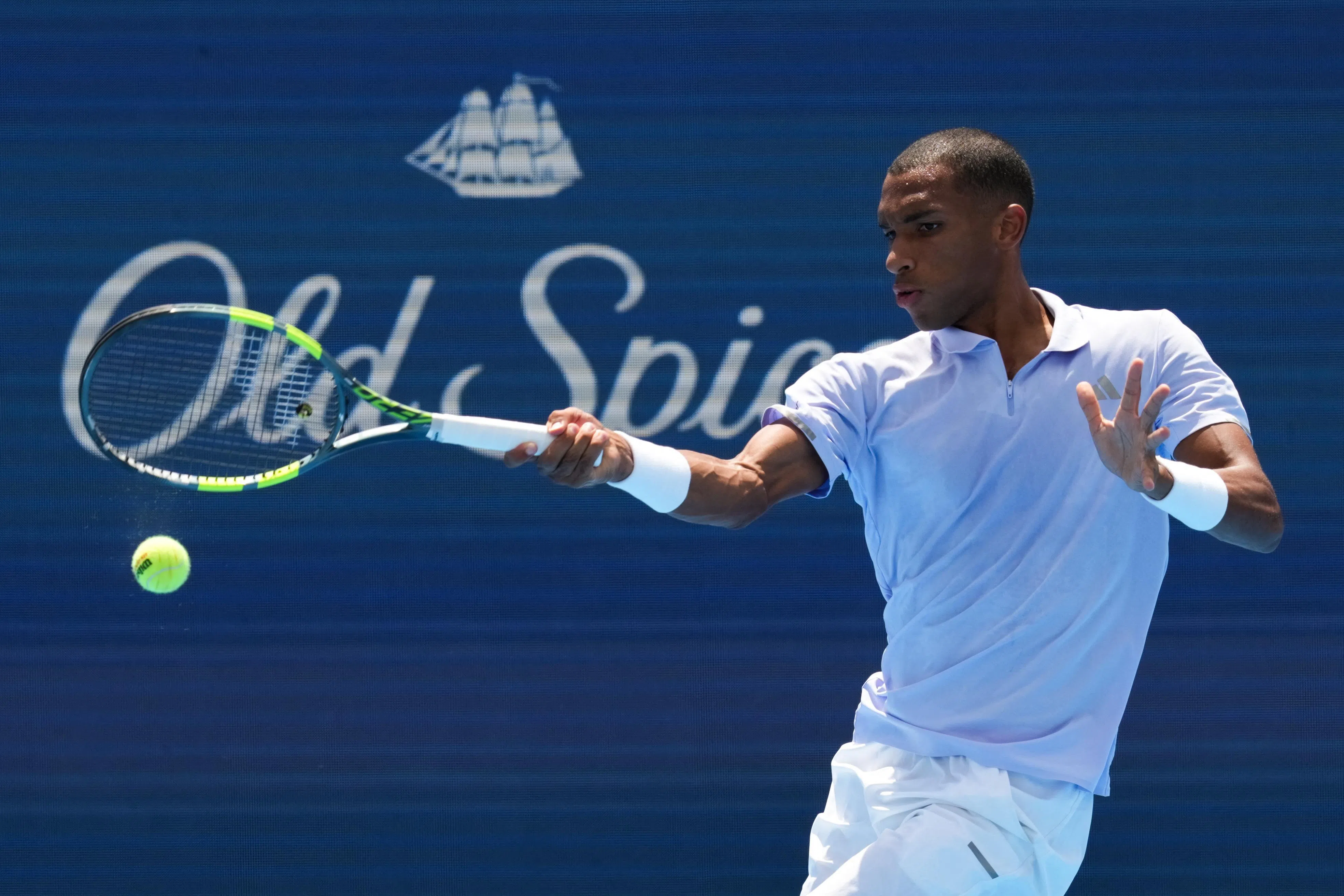 Canada’s Felix Auger Aliassime returns a shot against Greece’s Stefanos Tsitsipas.