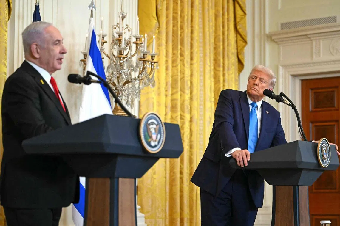 US President Donald Trump (R) listens to Israel's Prime Minister Benjamin Netanyahu speak during a press conference in the East Room of the White House in Washington, DC, on February 4, 2025. (Photo by ANDREW CABALLERO-REYNOLDS / AFP)