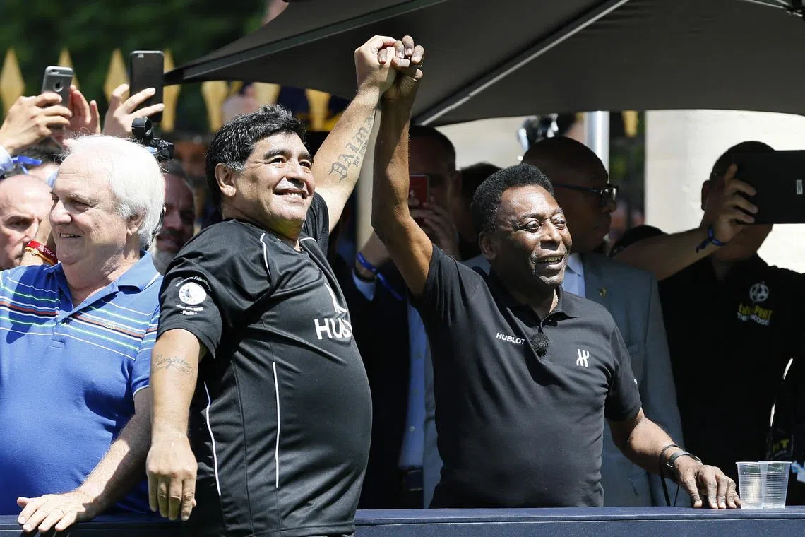 In this file photo taken on June 09, 2016 Former Argentinian football international Diego Maradona (L) and former Brazilian footballer Pele attend a football match organised by Swiss luxury watchmaker Hublot at the Jardin du Palais Royal in Paris on June 9, 2016, on the eve of the Euro 2016 European football championships. Brazilian football icon Pele, widely regarded as the greatest player of all time and a three-time World Cup winner who masterminded the 'beautiful game', died on December 29, 2022 at the age of 82, after battling kidney problems and colon cancer.