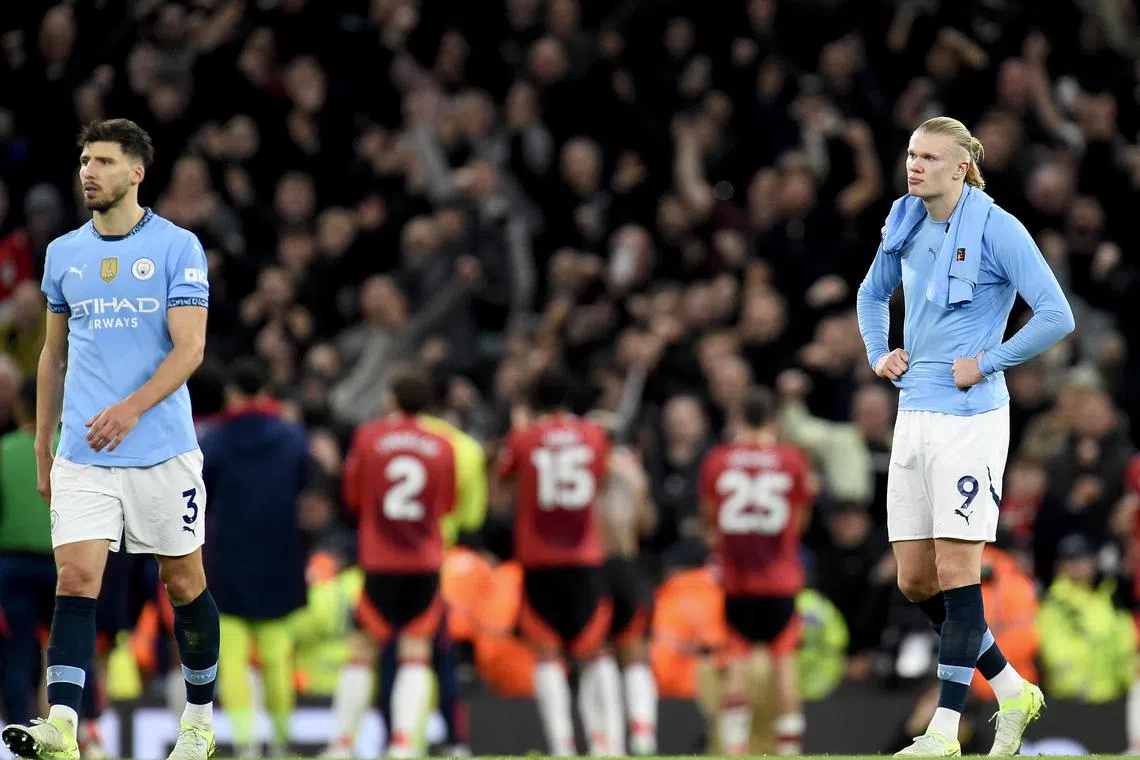 Manchester City's Erling Haaland (right) and Ruben Dias react after losing the match against Manchester United.