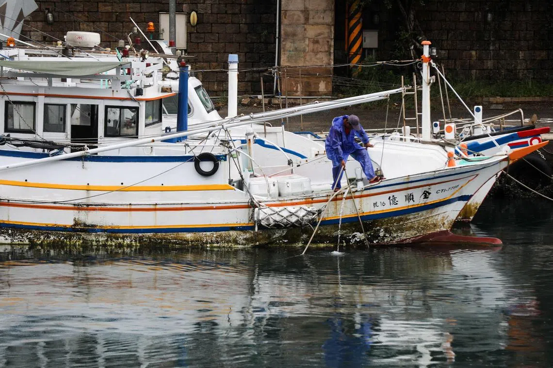 A fisherman secures his boat at the harbour in Keelung, Taiwan. China's recent purchases have been almost entirely limited to cuttlefish, squid and products not intended for human consumption