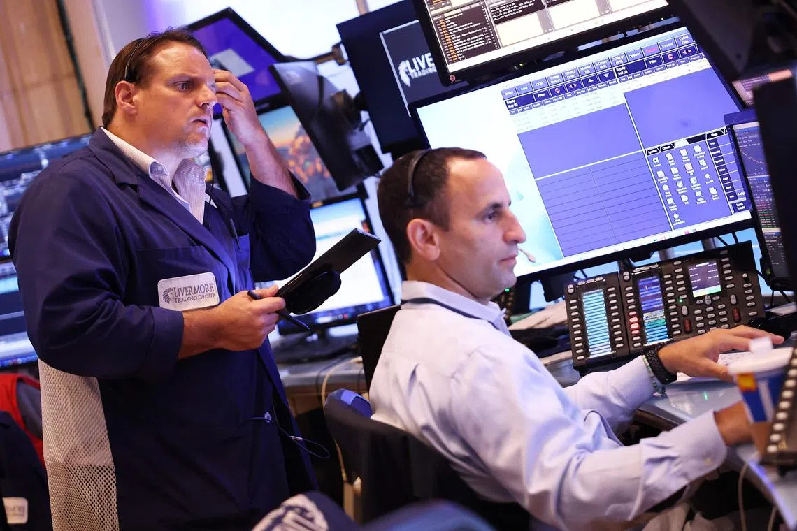 Traders work on the floor of the New York Stock Exchange, during morning trading on July 31, in New York City.