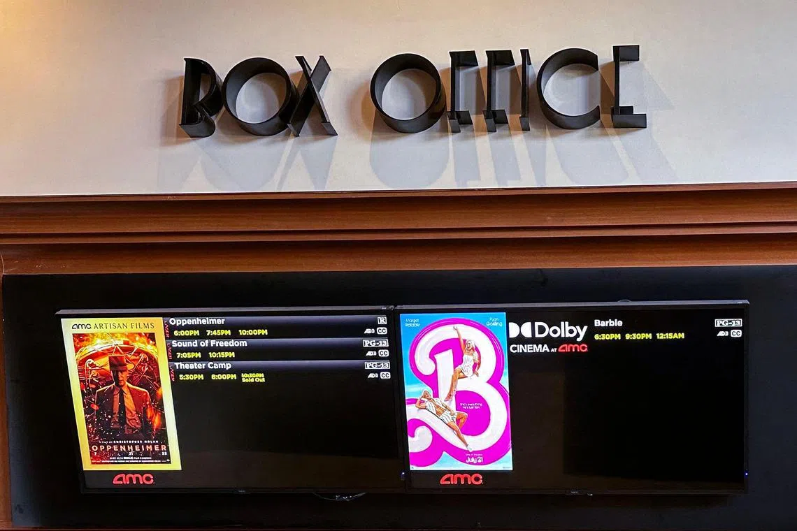 A movie theater Box Office is pictured announcing the opening of "Oppenheimer" and "Barbie" movies, in Los Angeles California, on July 20, 2023. "Oppenheimer" is facing off against "Barbie" in the biggest clash of Hollywood summer blockbusters, with both opening on the same day in a duel the media has dubbed "Barbenheimer". (Photo by VALERIE MACON / AFP)