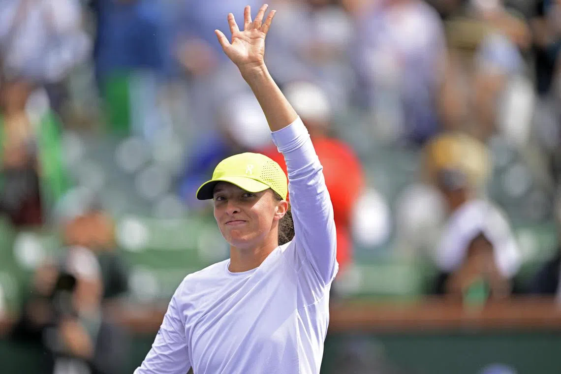Iga Swiatek waving to the crowd after defeating Karolina Muchova  during their fourth-round match.