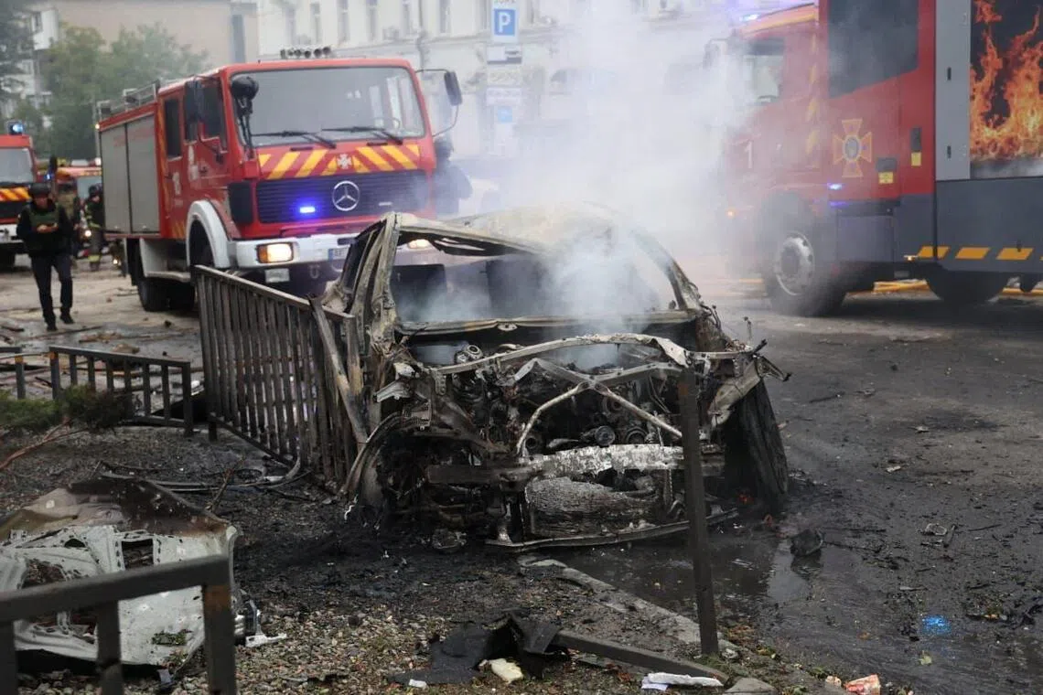 Rescuers working at the site of a Russian drone strike, in Dnipro, Ukraine, on Sept 30.