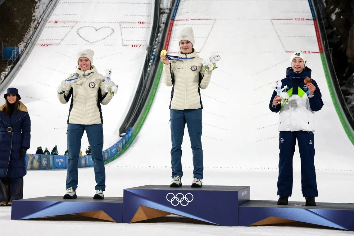 Milano Cortina 2026 Olympics - Ski Jumping - Women's Large Hill Individual Victory Ceremony - Predazzo Ski Jumping Stadium, Predazzo, Italy - February 15, 2026. Gold medallist Anna Odine Stroem of Norway celebrates on the podium after winning the Women's Large Hill Individual final with silver medallist Eirin Maria Kvandal of Norway and bronze medallist Nika Prevc of Slovenia REUTERS/Stephanie Lecocq