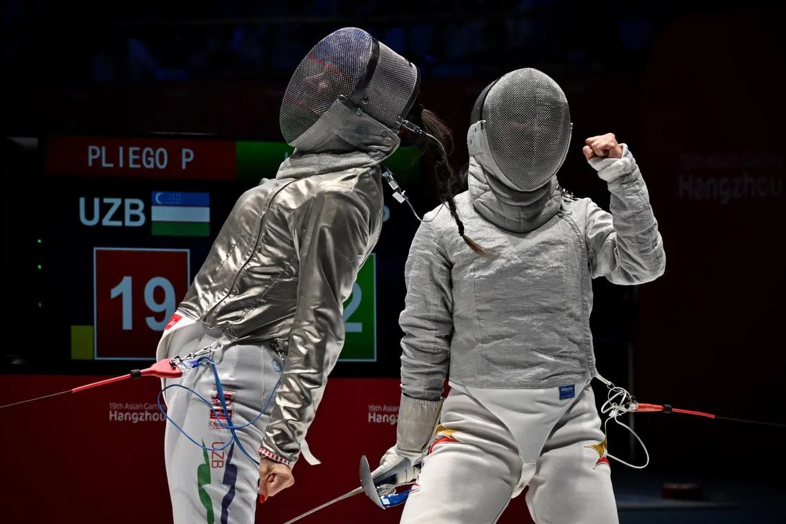 Uzbekistan’s Paola Pliego (left) and Singapore’s Jolie Lee showing their emotions during their women’s sabre team quarter-finals match.