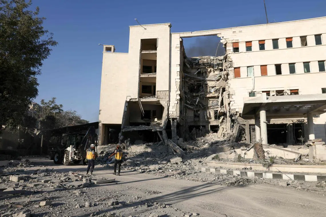Rescuers walk inside the heavily damaged Syrian army and defence ministry headquarters complex in Damascus, following Israeli strikes on July 16.