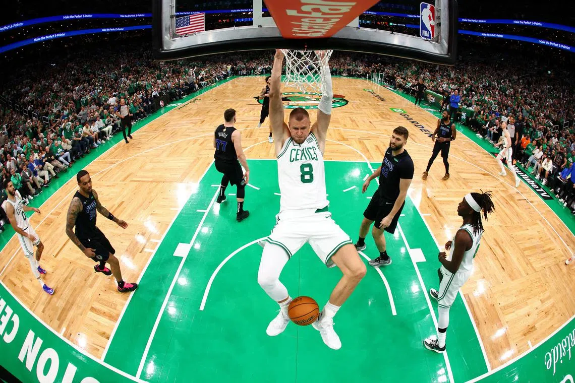 Boston Celtics centre Kristaps Porzingis dunks the ball against the Dallas Mavericks during the first quarter of Game 1 of the NBA Finals.