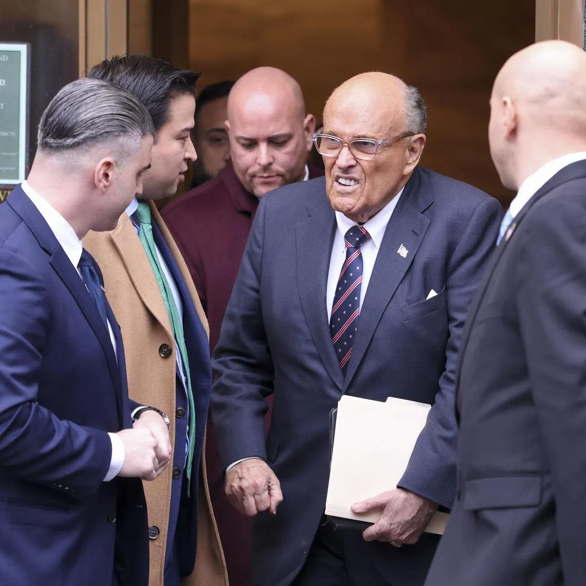 Rudy Giuliani (centre) leaving his court hearing in Georgia, on Nov 26.